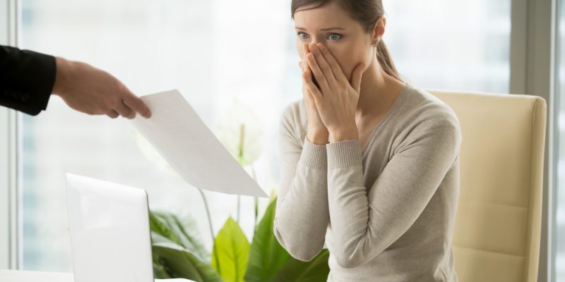 employer-giving-dismissal-notice-to-young-woman
